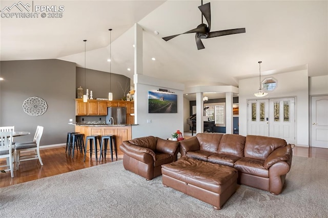 15090 Jessie Dr, Colorado Springs, CO 80921 - living room with high vaulted ceiling, ceiling fan, wood finished floors, and baseboards