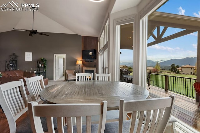 15090 Jessie Dr, Colorado Springs, CO 80921 - dining room with a fireplace, wood finished floors, ceiling fan, and high vaulted ceiling