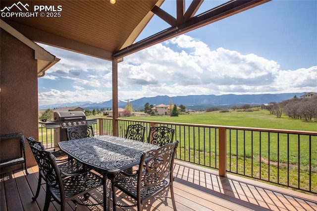 15090 Jessie Dr, Colorado Springs, CO 80921 - deck featuring a mountain view, a yard, outdoor dining area, and a grill