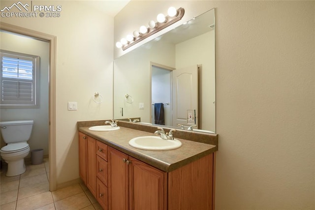 15090 Jessie Dr, Colorado Springs, CO 80921 - full bath featuring double vanity, tile patterned flooring, and toilet