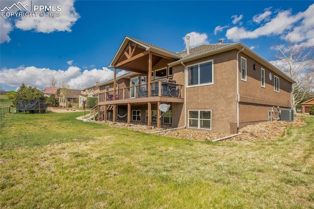 15090 Jessie Dr, Colorado Springs, CO 80921 - back of property with central air condition unit, a wooden deck, stucco siding, and a lawn