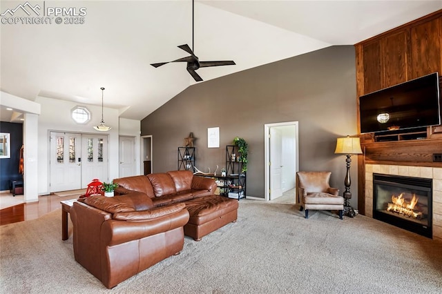15090 Jessie Dr, Colorado Springs, CO 80921 - living room with high vaulted ceiling, a ceiling fan, carpet flooring, a tile fireplace, and baseboards