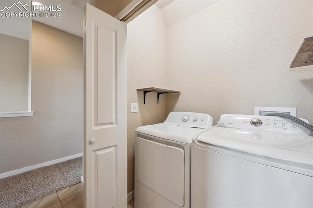 laundry area featuring washing machine and clothes dryer, laundry area, and baseboards