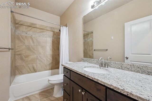 full bath featuring shower / bath combo, vanity, and toilet