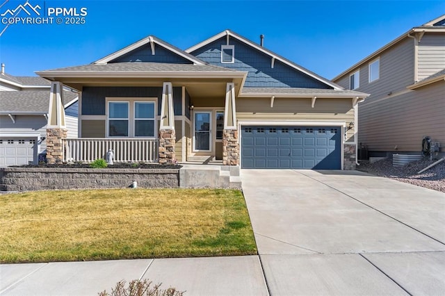 1185 Antrim Loop, Colorado Springs, CO 80910 - craftsman-style home featuring a porch, a front yard, stone siding, an attached garage, and concrete driveway