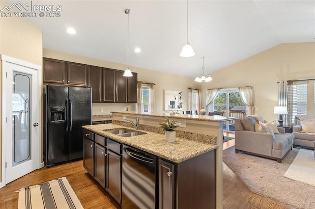 1185 Antrim Loop, Colorado Springs, CO 80910 - kitchen with dark brown cabinetry, vaulted ceiling, open floor plan, black appliances, and a sink
