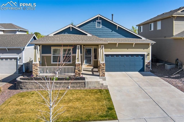 1185 Antrim Loop, Colorado Springs, CO 80910 - craftsman house featuring an attached garage, stone siding, covered porch, driveway, and roof with shingles