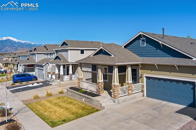 1185 Antrim Loop, Colorado Springs, CO 80910 - view of front of house featuring concrete driveway, roof with shingles, stone siding, a porch, and a garage