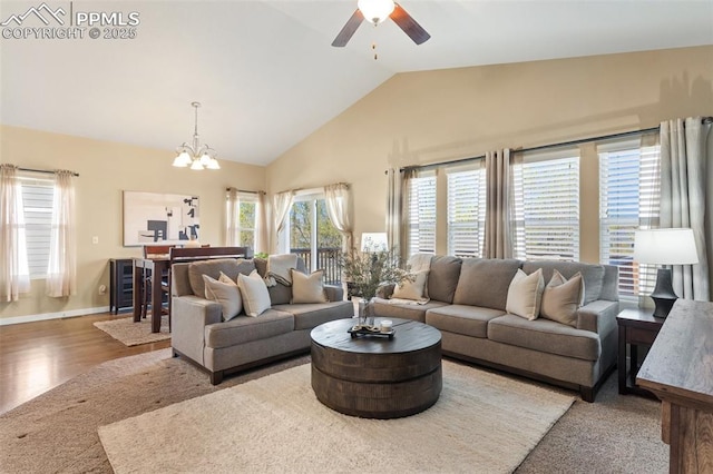1185 Antrim Loop, Colorado Springs, CO 80910 - living area featuring baseboards, vaulted ceiling, beverage cooler, ceiling fan with notable chandelier, and wood finished floors