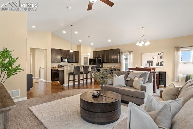 1185 Antrim Loop, Colorado Springs, CO 80910 - living area featuring recessed lighting, dark wood-style floors, visible vents, high vaulted ceiling, and ceiling fan with notable chandelier