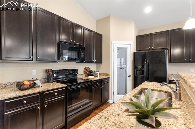 1185 Antrim Loop, Colorado Springs, CO 80910 - kitchen featuring light stone countertops, dark brown cabinets, black appliances, wood finished floors, and a sink