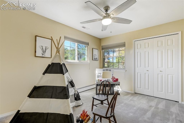 660 Pony Ln, Colorado Springs, CO 80904 - carpeted bedroom with baseboard heating, a closet, baseboards, a ceiling fan, and visible vents