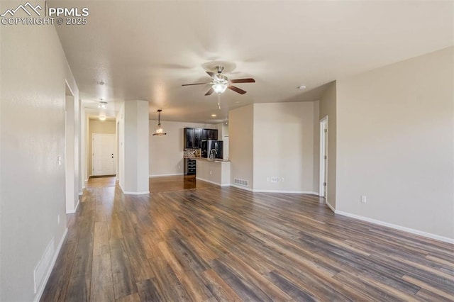 7935 Morning Dew Rd, Colorado Springs, CO 80908 - unfurnished living room with visible vents, baseboards, a ceiling fan, and dark wood finished floors