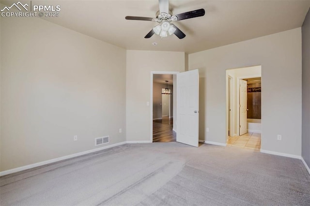 7935 Morning Dew Rd, Colorado Springs, CO 80908 - unfurnished bedroom with light carpet, baseboards, visible vents, and ensuite bath