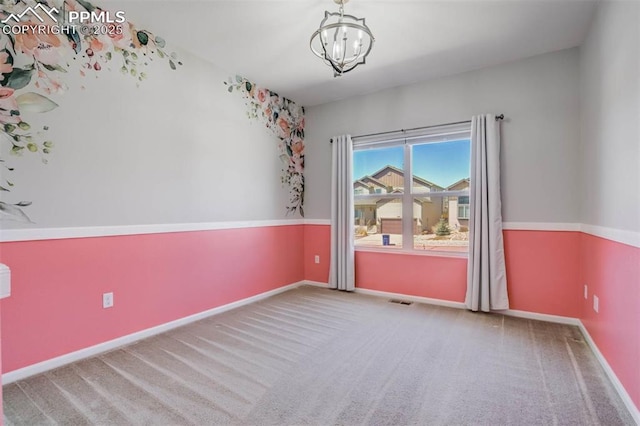 7935 Morning Dew Rd, Colorado Springs, CO 80908 - spare room with visible vents, baseboards, an inviting chandelier, and carpet floors
