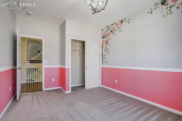 7935 Morning Dew Rd, Colorado Springs, CO 80908 - unfurnished bedroom with carpet flooring, a notable chandelier, a closet, and baseboards