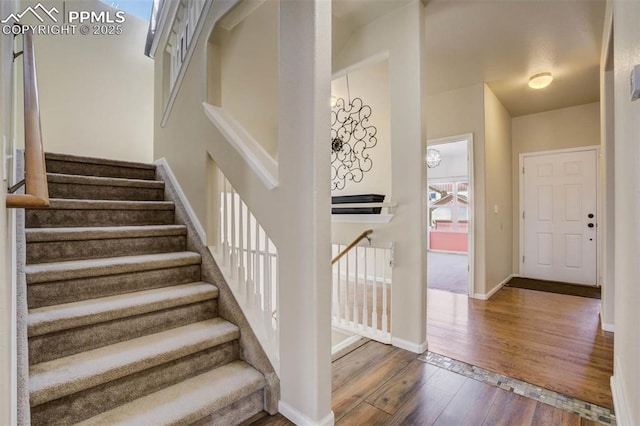 7935 Morning Dew Rd, Colorado Springs, CO 80908 - foyer featuring wood-type flooring, baseboards, and stairs