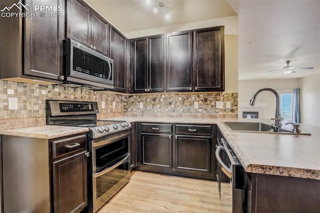 7935 Morning Dew Rd, Colorado Springs, CO 80908 - kitchen featuring a sink, light countertops, appliances with stainless steel finishes, a ceiling fan, and light wood finished floors