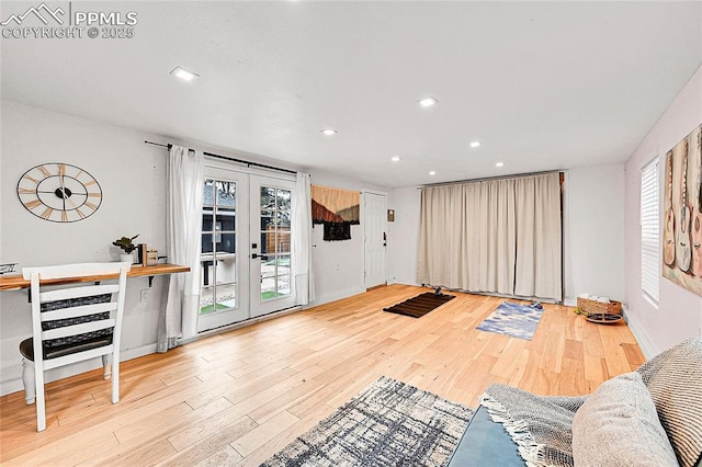 unfurnished living room featuring baseboards, french doors, wood finished floors, and recessed lighting