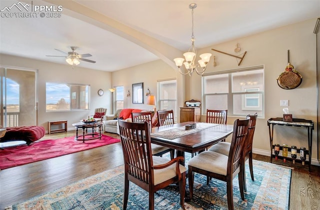 9825 Golf Crest Dr, Peyton, CO 80831 - dining room featuring baseboards, arched walkways, wood finished floors, and ceiling fan with notable chandelier