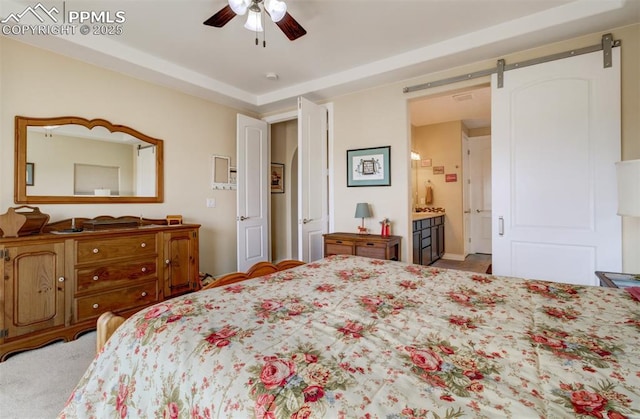 9825 Golf Crest Dr, Peyton, CO 80831 - bedroom featuring ceiling fan, ensuite bath, and a barn door
