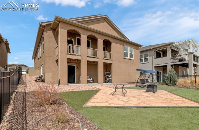 9825 Golf Crest Dr, Peyton, CO 80831 - back of house with an outdoor fire pit, a patio area, stucco siding, and a fenced backyard