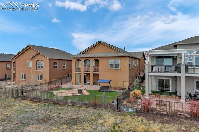 9825 Golf Crest Dr, Peyton, CO 80831 - back of property featuring a patio area, a fenced backyard, stucco siding, and a balcony