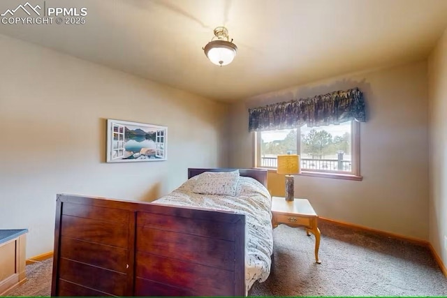 bedroom with carpet flooring and baseboards