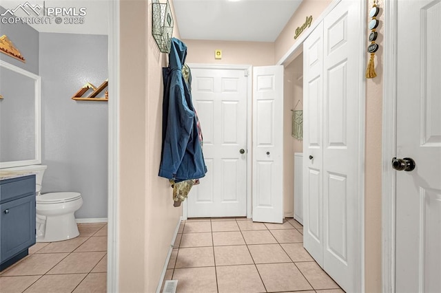 full bathroom featuring vanity, baseboards, tile patterned flooring, toilet, and visible vents