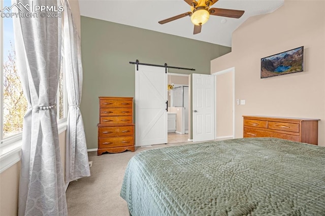 bedroom featuring baseboards, a barn door, a ceiling fan, vaulted ceiling, and light colored carpet