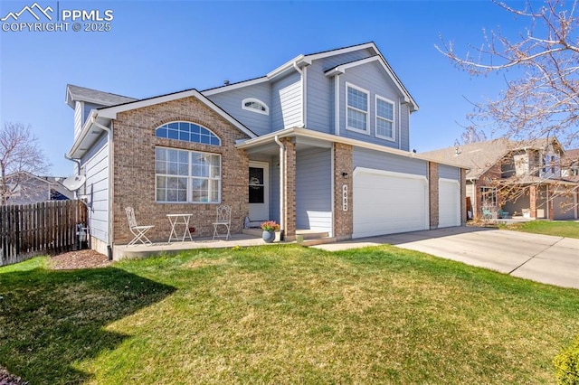 traditional-style home with driveway, a front lawn, brick siding, a garage, and fence