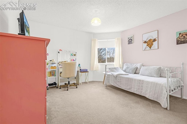 carpeted bedroom featuring a textured ceiling and baseboards