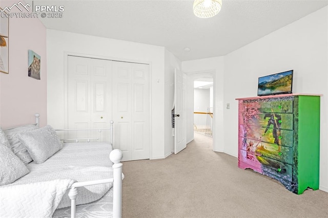 bedroom featuring a closet, baseboards, and carpet
