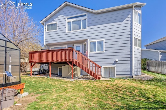 back of house featuring an outdoor structure, an exterior structure, stairs, central AC, and a lawn