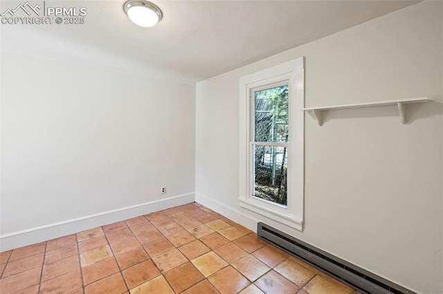 spare room with a baseboard radiator and baseboards