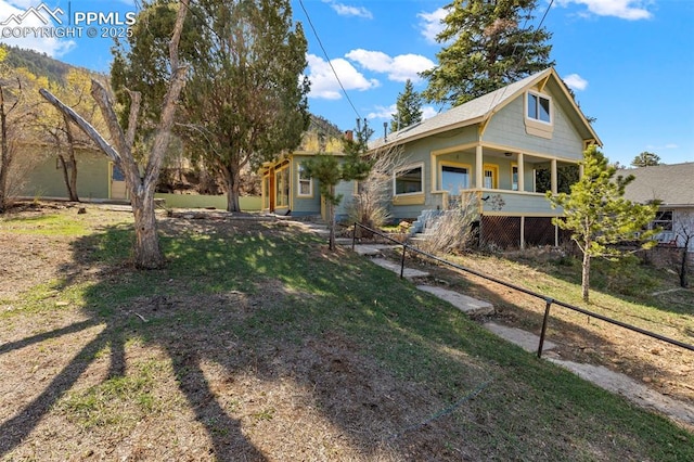 exterior space featuring a yard, stairway, and covered porch