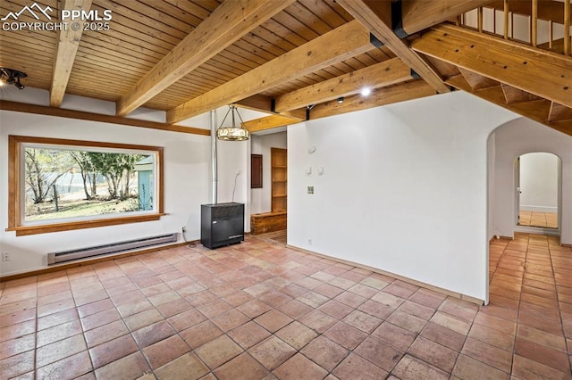 empty room featuring baseboards, a baseboard heating unit, beamed ceiling, arched walkways, and wood ceiling