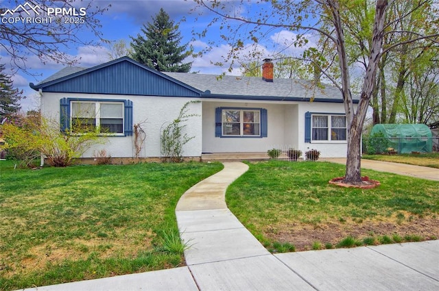 2354 Valley Forge Rd, Colorado Springs, CO 80907 - ranch-style home featuring stucco siding, a chimney, and a front yard