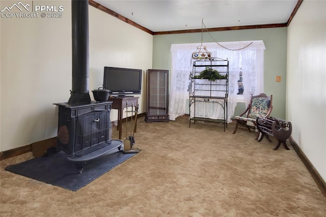 2354 Valley Forge Rd, Colorado Springs, CO 80907 - interior space featuring crown molding, carpet flooring, a wood stove, and baseboards