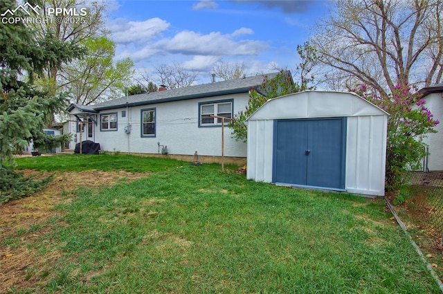 2354 Valley Forge Rd, Colorado Springs, CO 80907 - rear view of house with an outdoor structure, a chimney, a yard, and a shed