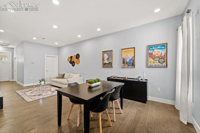 dining room featuring recessed lighting, baseboards, and wood finished floors