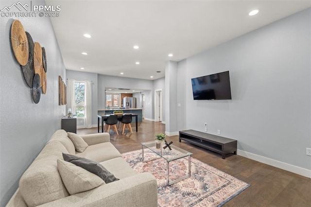 living area featuring wood finished floors, baseboards, and recessed lighting