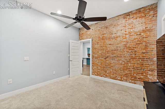 unfurnished room featuring baseboards, brick wall, ceiling fan, carpet, and recessed lighting