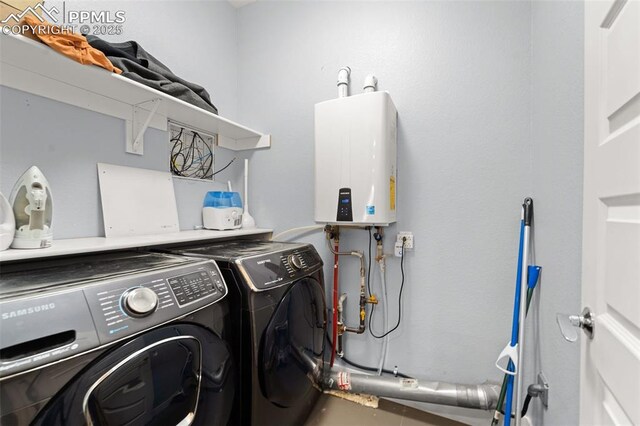 clothes washing area featuring laundry area, washing machine and clothes dryer, and water heater