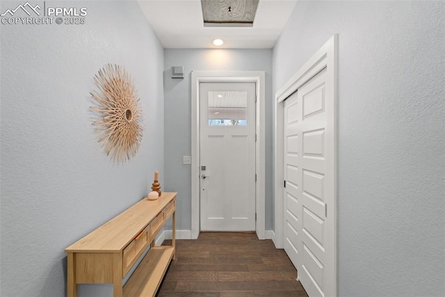 doorway to outside with dark wood-type flooring and baseboards