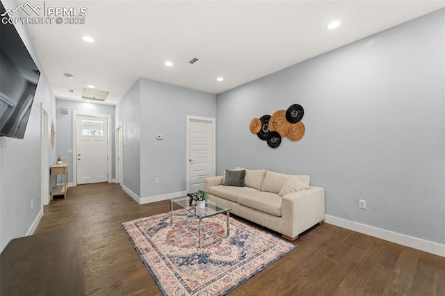 living area with wood finished floors, baseboards, and recessed lighting