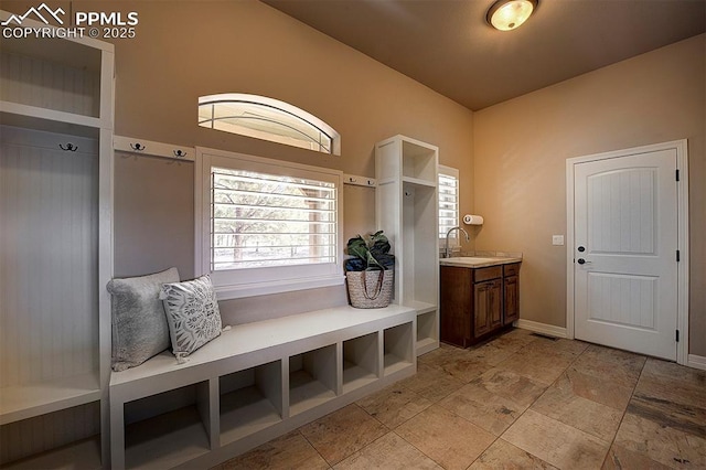 mudroom with a sink and baseboards