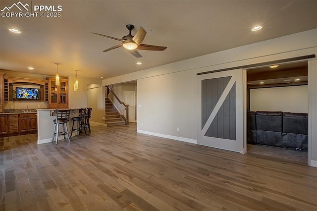 living room featuring baseboards, dark wood-style flooring, a ceiling fan, stairway, and recessed lighting