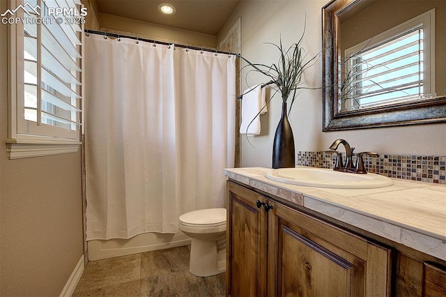 full bath with tasteful backsplash, toilet, plenty of natural light, and vanity