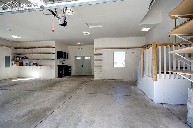 garage featuring electric panel and a garage door opener